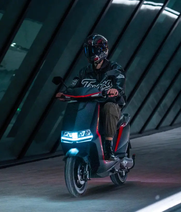 Person riding a scooter in a modern architectural setting